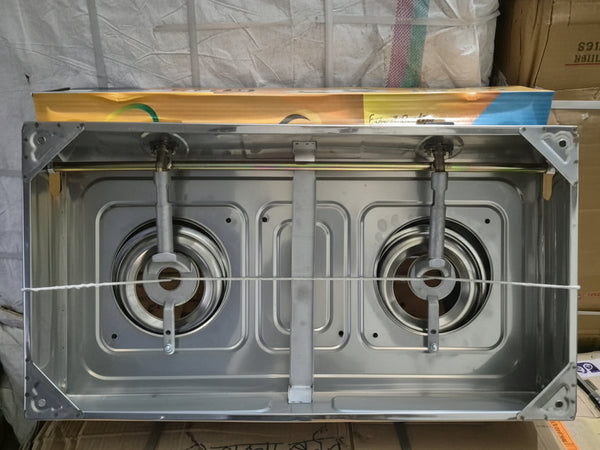 Stainless steel gas stove with two burners on a cardboard box background