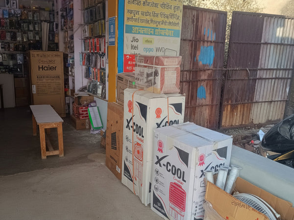 Stack of boxes with product packaging on a concrete floor