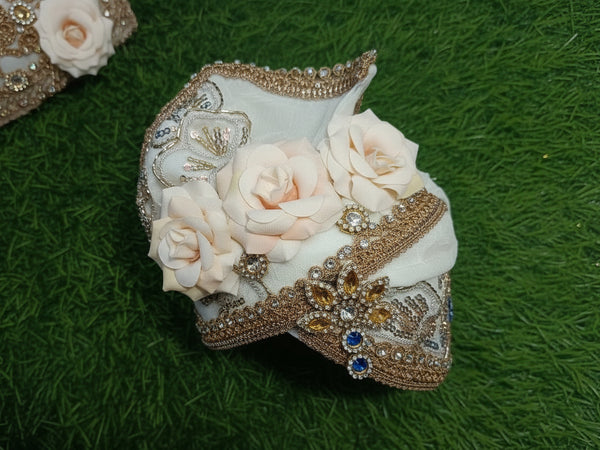 Decorative headband with flowers and embellishments on a green grass background
