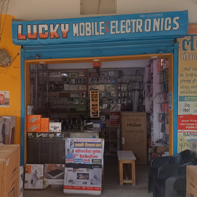 Entrance to Lucky Mobile Electronics store with various electronic items and boxes inside.