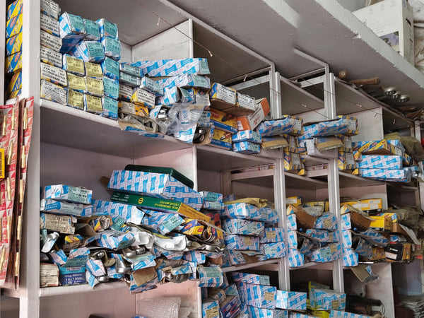 Shelves filled with various boxes and packages in a storage or warehouse setting.