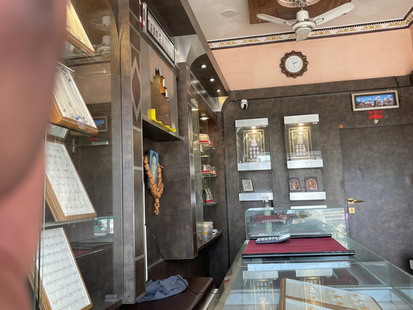Interior of a jewelry store with glass display cases and shelves.
