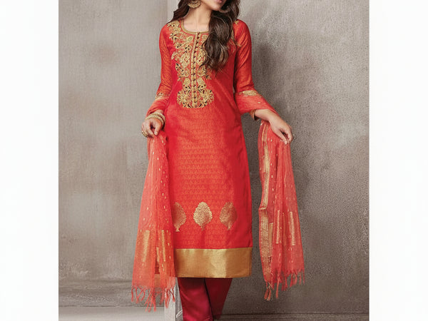 Woman wearing a red embroidered traditional outfit with a plain background