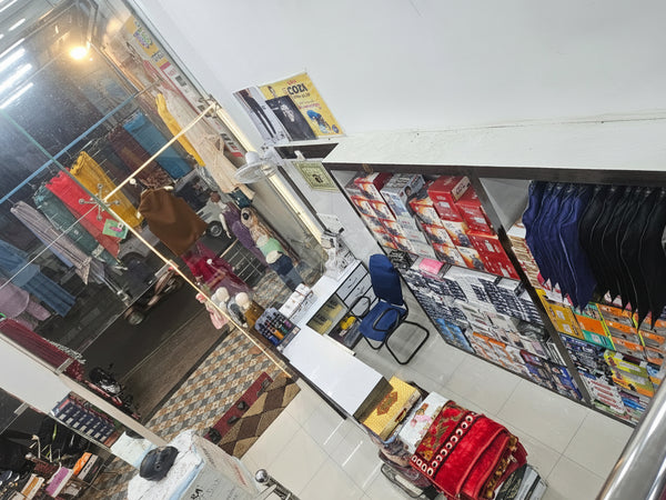 Interior of a store with various products displayed on shelves and tables.