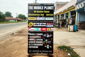 Advertisement board for 'The Mobile Planet' with various mobile phone brands and services.