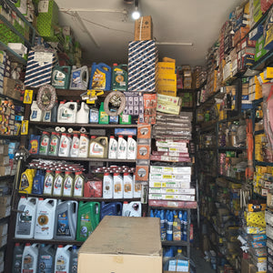 Shelves stocked with various automotive products in a garage or parts store.