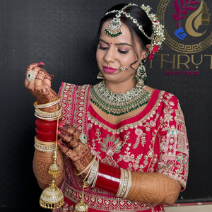 Bridal makeup in red lehenga with green jewellery and mehndi – Shruti Beauty Salon