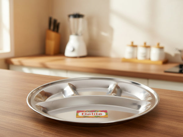 Stainless steel divided plate with 'Delite' brand label on a dark surface