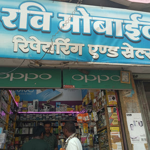 Shopfront with a blue signboard featuring white text and multiple brand logos.
