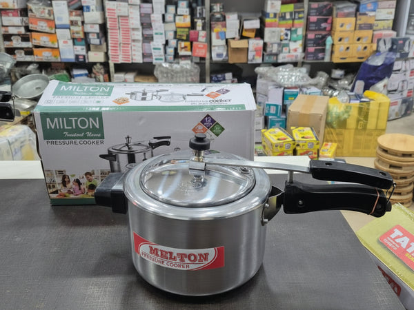 Milton pressure cooker on a counter with packaging in the background