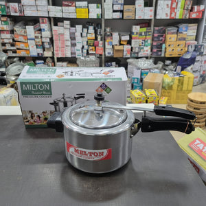 Milton pressure cooker on a counter with packaging in the background